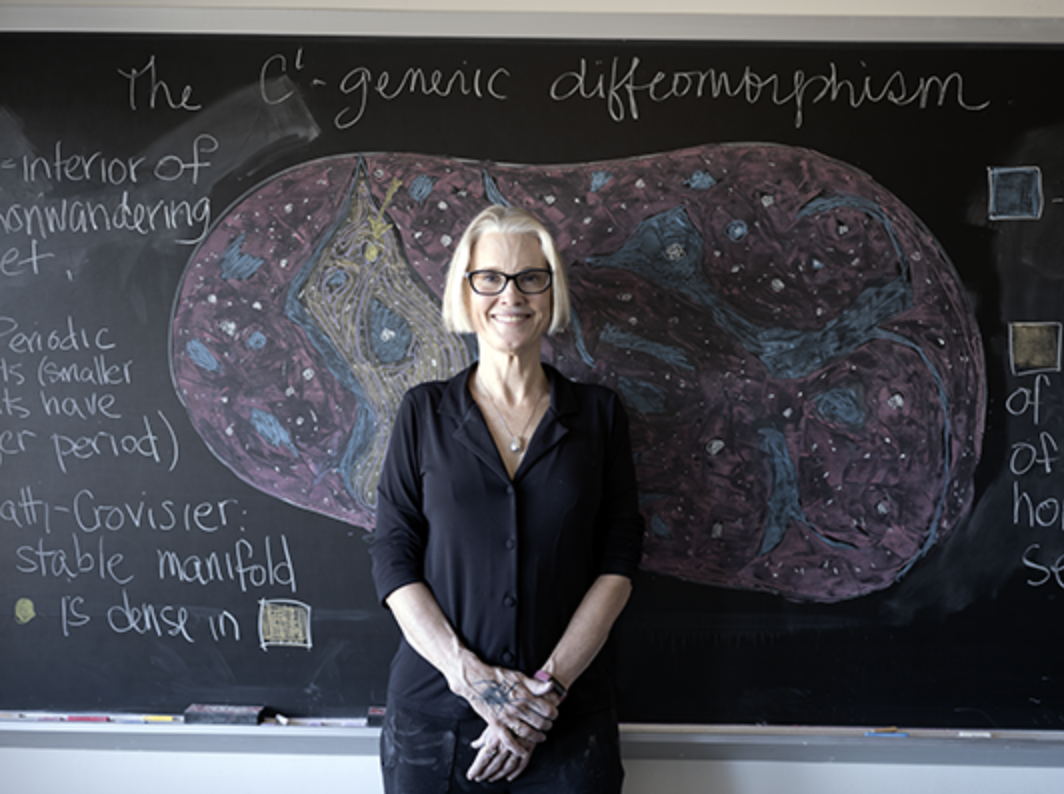 Amie Wilkinson in front of a chalkboard.